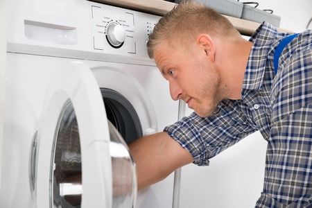 professional technician repairing a washer